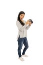 Young beautiful hispanic photographer woman smiling happy taking photo with reflex camera Royalty Free Stock Photo