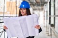 Young beautiful hispanic woman architect looking house plans at street Royalty Free Stock Photo