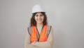 Young beautiful hispanic woman builder smiling confident standing with arms crossed gesture over isolated white background Royalty Free Stock Photo