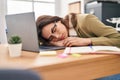 Young beautiful hispanic woman business worker leaning on laptop sleeping at office Royalty Free Stock Photo