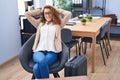 Young beautiful hispanic woman business worker relaxed waiting for travel at office