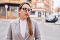 Young beautiful hispanic woman business worker standing with serious expression at street Royalty Free Stock Photo