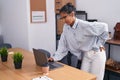 Young beautiful hispanic woman business worker suffering for backache at office Royalty Free Stock Photo