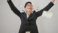 Young beautiful hispanic woman business worker throwing chilean pesos on air over isolated white background Royalty Free Stock Photo