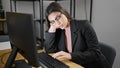 Young beautiful hispanic woman business worker tired using computer working at office Royalty Free Stock Photo