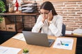 Young beautiful hispanic woman business worker tired using laptop working at office Royalty Free Stock Photo