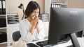 Young beautiful hispanic woman business worker using computer sneezing at office Royalty Free Stock Photo