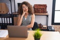 Young beautiful hispanic woman business worker using laptop with doubt expression at office Royalty Free Stock Photo