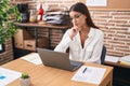 Young beautiful hispanic woman business worker using laptop with doubt expression at office Royalty Free Stock Photo