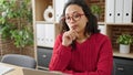 Young beautiful hispanic woman business worker using laptop with doubt expression at office Royalty Free Stock Photo