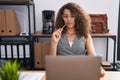 Young beautiful hispanic woman business worker using laptop with doubt expression at office Royalty Free Stock Photo