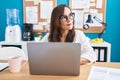 Young beautiful hispanic woman business worker using laptop with serious expression at office Royalty Free Stock Photo