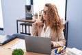 Young beautiful hispanic woman business worker using laptop with serious expression at office Royalty Free Stock Photo