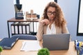 Young beautiful hispanic woman business worker using laptop with serious expression at office Royalty Free Stock Photo