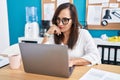 Young beautiful hispanic woman business worker using laptop with serious expression at office Royalty Free Stock Photo