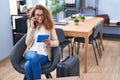 Young beautiful hispanic woman business worker waiting for travel talking on smartphone at office