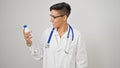 Young beautiful hispanic woman doctor smiling confident holding medication bottle over isolated white background Royalty Free Stock Photo