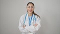 Young beautiful hispanic woman doctor smiling confident standing with arms crossed gesture over isolated white background Royalty Free Stock Photo