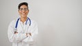 Young beautiful hispanic woman doctor smiling confident standing with arms crossed gesture over isolated white background Royalty Free Stock Photo