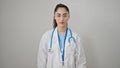 Young beautiful hispanic woman doctor standing with serious expression over isolated white background Royalty Free Stock Photo