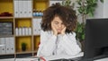 Young beautiful hispanic woman doctor tired working at clinic