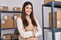 Young beautiful hispanic woman ecommerce business worker standing with arms crossed gesture at office Royalty Free Stock Photo