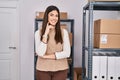 Young beautiful hispanic woman ecommerce business worker standing with arms crossed gesture at office Royalty Free Stock Photo