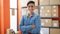 Young beautiful hispanic woman ecommerce business worker standing with arms crossed gesture at office Royalty Free Stock Photo