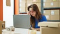 Young beautiful hispanic woman ecommerce business worker using laptop working stressed at office Royalty Free Stock Photo