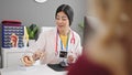 Young beautiful hispanic woman gynecologist having gynecology consultation with patient at clinic