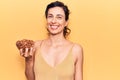 Young beautiful hispanic woman holding bowl with almonds looking positive and happy standing and smiling with a confident smile Royalty Free Stock Photo