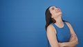 Young beautiful hispanic woman laughing a lot standing over isolated blue background Royalty Free Stock Photo