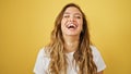 Young beautiful hispanic woman laughing a lot standing over isolated yellow background Royalty Free Stock Photo