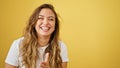 Young beautiful hispanic woman laughing a lot standing over isolated yellow background Royalty Free Stock Photo