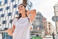 Young beautiful hispanic woman listening to music and dancing at street Royalty Free Stock Photo