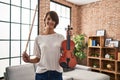 Young beautiful hispanic woman musician smiling confident holding violin at home Royalty Free Stock Photo