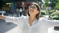 Young beautiful hispanic woman with open arms in the streets of Madrid Royalty Free Stock Photo