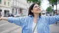 Young beautiful hispanic woman with open arms in the streets of Vienna Royalty Free Stock Photo