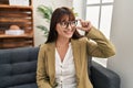 Young beautiful hispanic woman psychologist smiling confident sitting on sofa at office Royalty Free Stock Photo