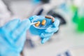 Young beautiful hispanic woman scientist holding pill at laboratory Royalty Free Stock Photo