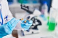 Young beautiful hispanic woman scientist holding pill at laboratory Royalty Free Stock Photo