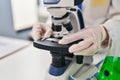 Young beautiful hispanic woman scientist looking sample on microscope at laboratory Royalty Free Stock Photo