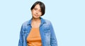 Young beautiful hispanic woman with short hair wearing casual denim jacket looking sleepy and tired, exhausted for fatigue and Royalty Free Stock Photo