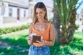 Young beautiful hispanic woman smiling confident counting dollars at park Royalty Free Stock Photo