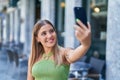 Young beautiful hispanic woman smiling confident making selfie by the smartphone at coffee shop terrace Royalty Free Stock Photo