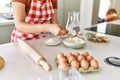 Young beautiful hispanic woman smiling confident pouring flour on bowl at the kitchen Royalty Free Stock Photo