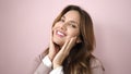 Young beautiful hispanic woman smiling confident touching face with hands over isolated pink background Royalty Free Stock Photo