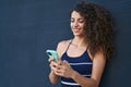Young beautiful hispanic woman smiling confident using smartphone over isolated black background Royalty Free Stock Photo