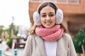 Young beautiful hispanic woman smiling confident wearing scarf and earmuff at street Royalty Free Stock Photo