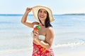 Young beautiful hispanic woman toruist smiling confident eating ice cream at seaside Royalty Free Stock Photo